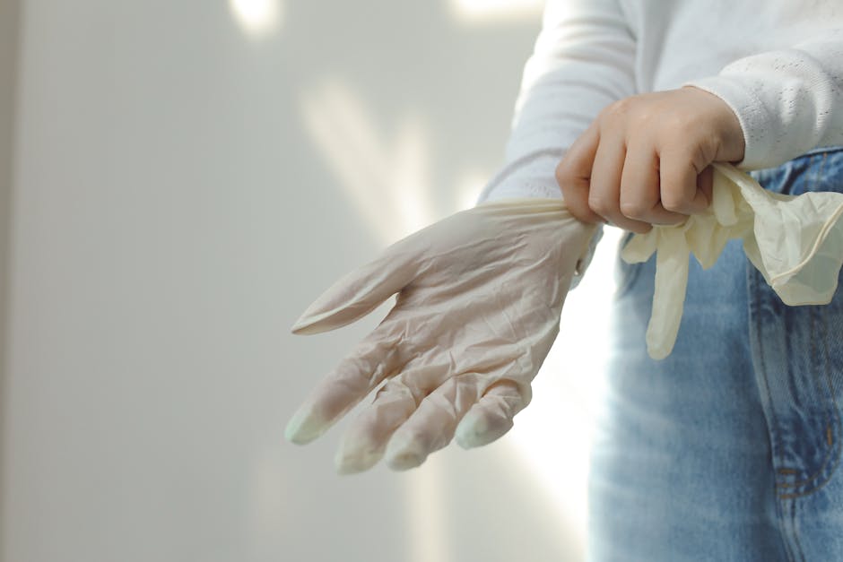 Close-up of a person wearing protective latex gloves for hygiene and safety.